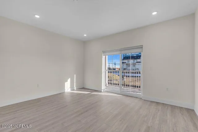 a kitchen with a refrigerator and a stove top oven