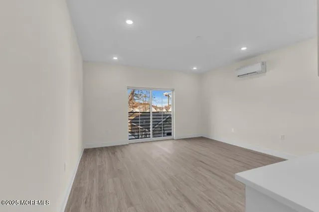 a view of a kitchen with a sink and dishwasher a fireplace with wooden floor