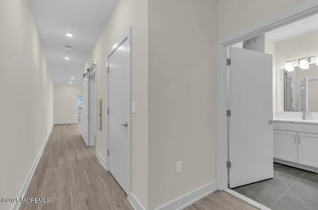 a large bed sitting in a room next to a chandelier