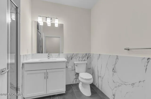 a living room with furniture a potted plant and a fireplace