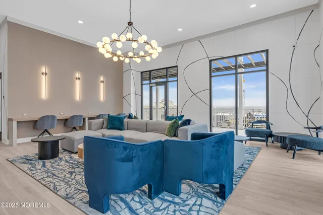 a living room with fireplace furniture and a chandelier