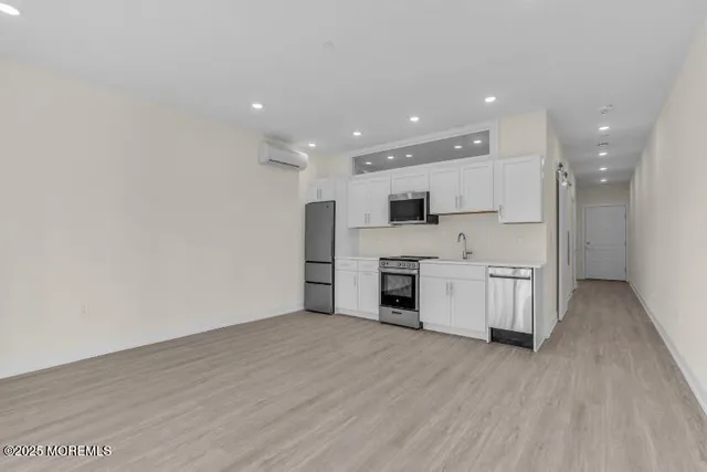 a kitchen with stainless steel appliances a refrigerator sink and microwave