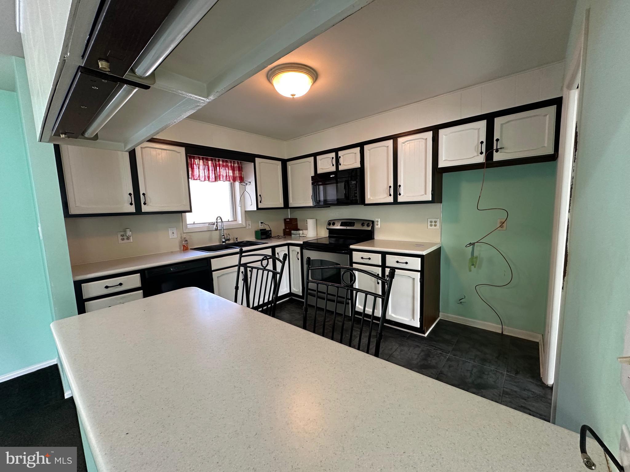 2776 Stevens Summit Drive Columbia, PA 17512 - Photo 9 of 39 a kitchen with stainless steel appliances a sink a stove a refrigerator cabinets and a dining table
