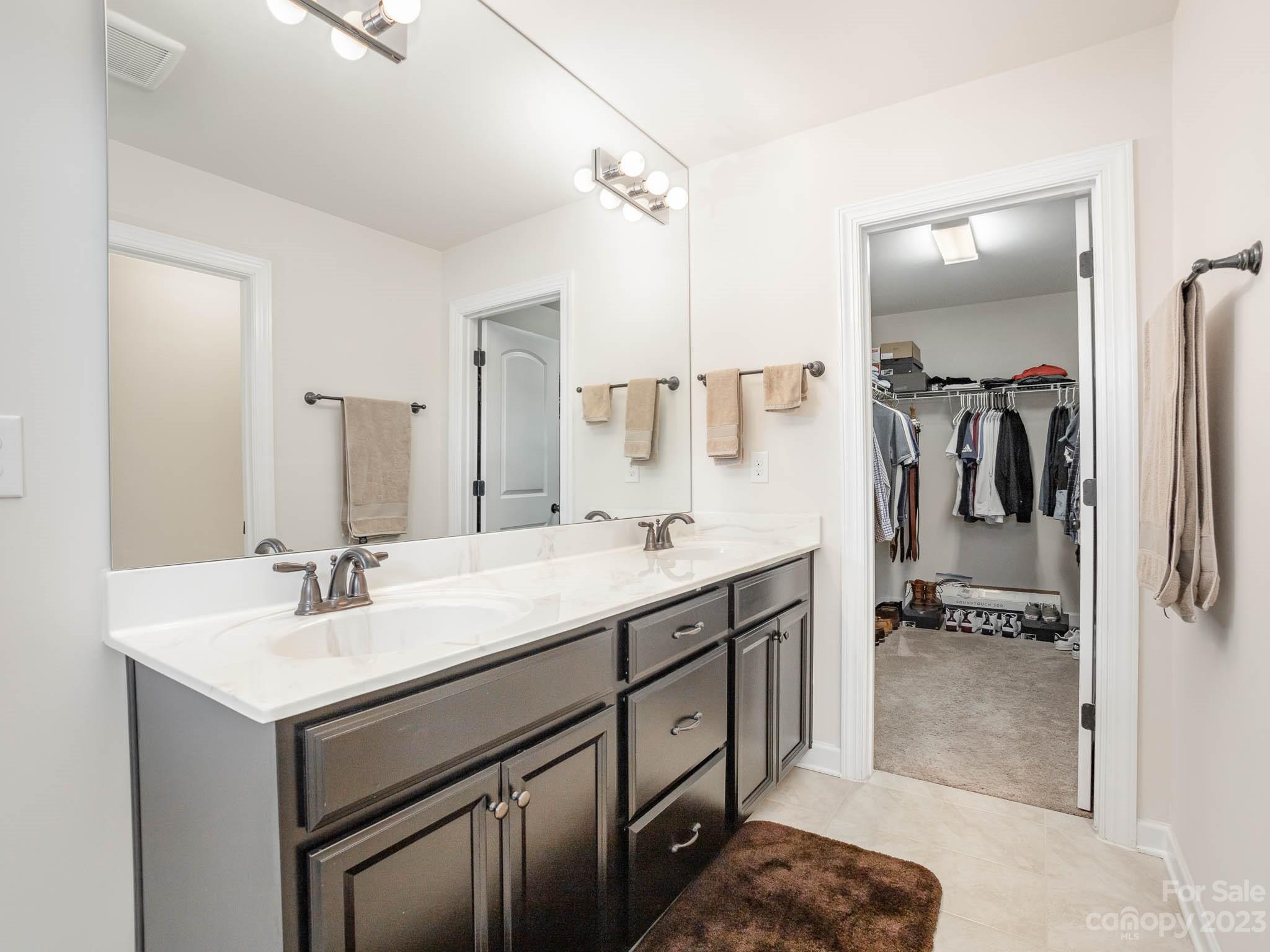 5688 Garrow Glen Road Charlotte, NC 28278 - Photo 13 of 30 a spacious bathroom with a sink double vanity and a mirror