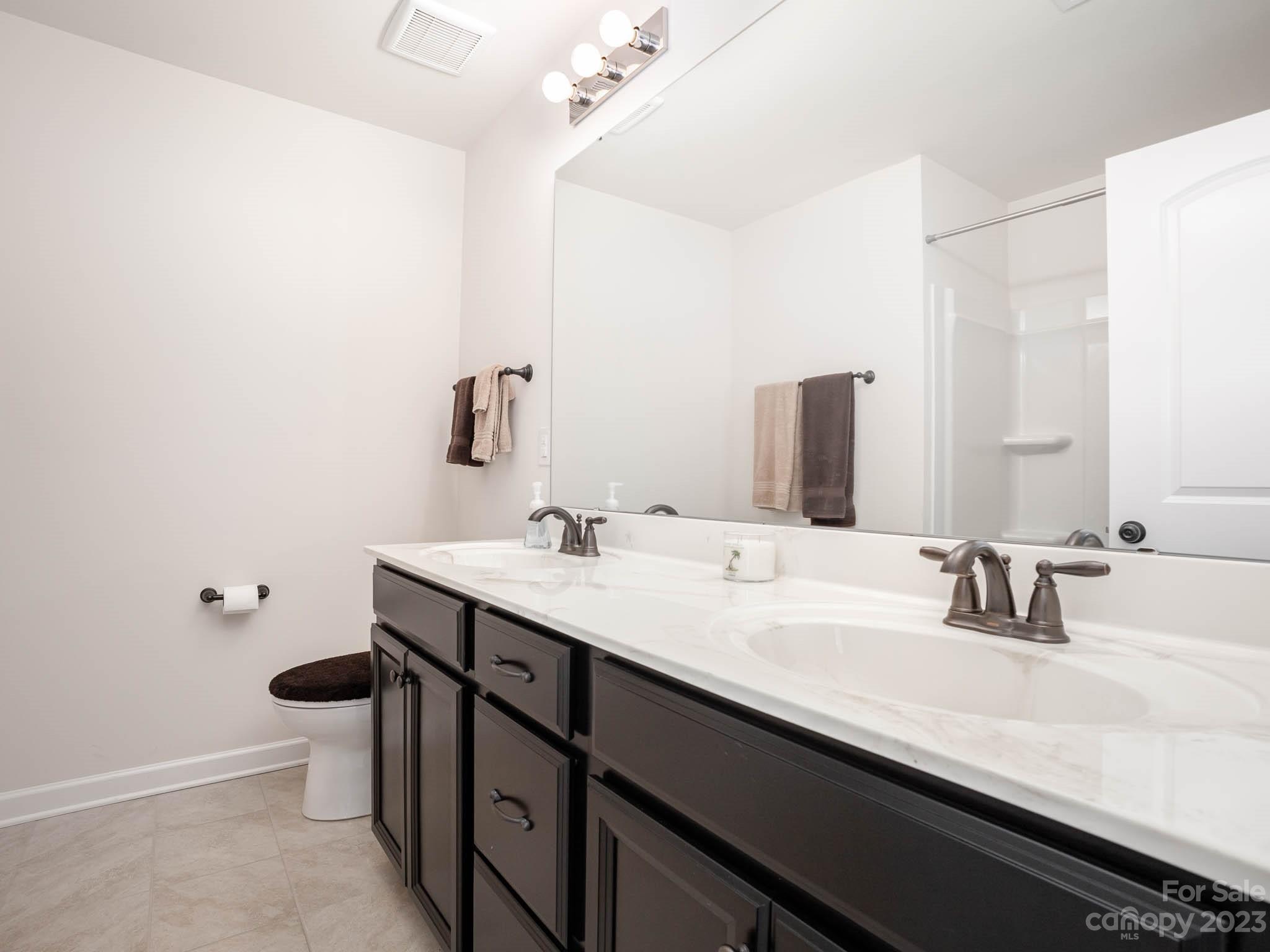 5688 Garrow Glen Road Charlotte, NC 28278 - Photo 14 of 30 a bathroom with a sink and a mirror