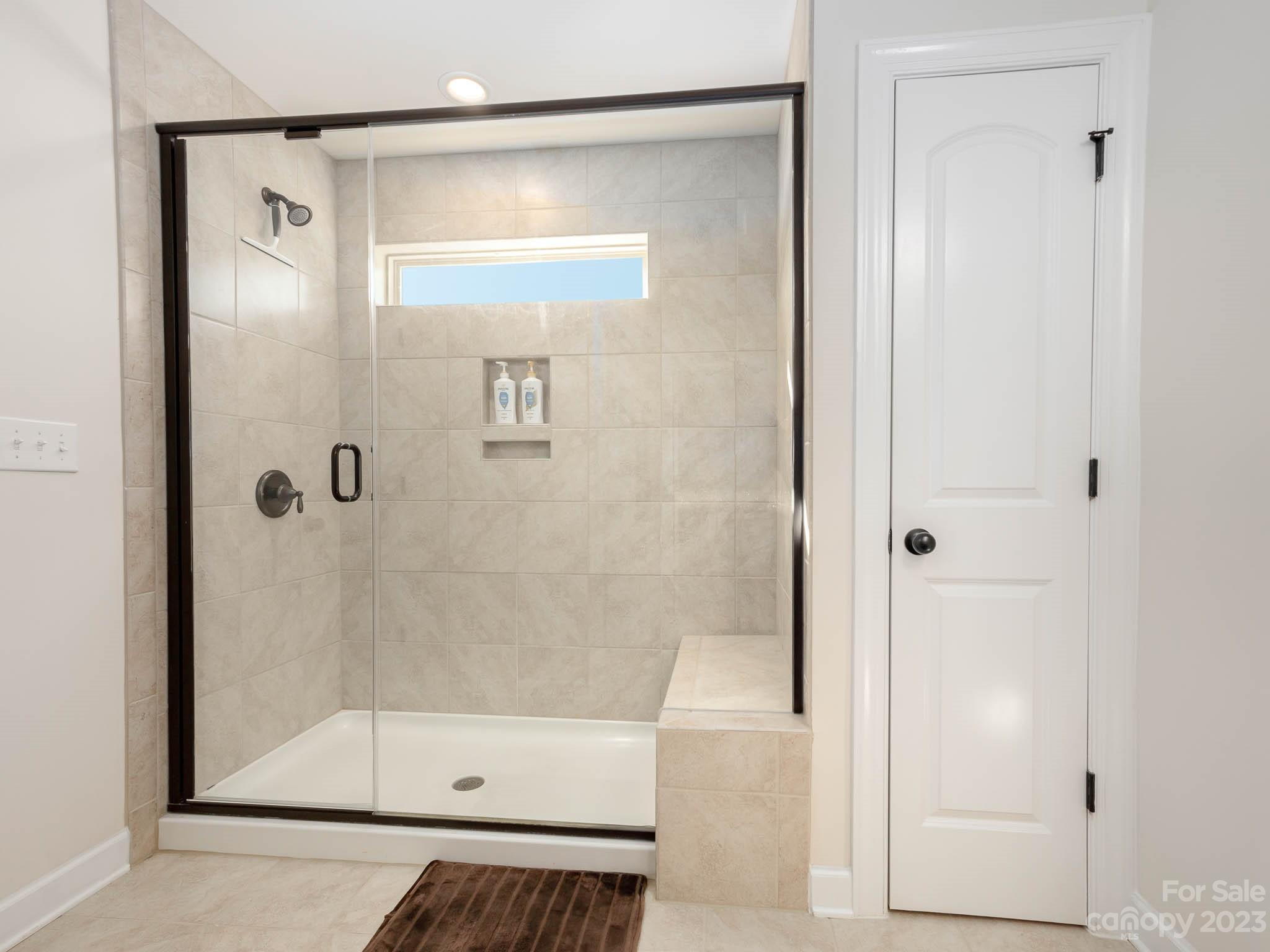 5688 Garrow Glen Road Charlotte, NC 28278 - Photo 15 of 30 a bathroom with a glass shower door