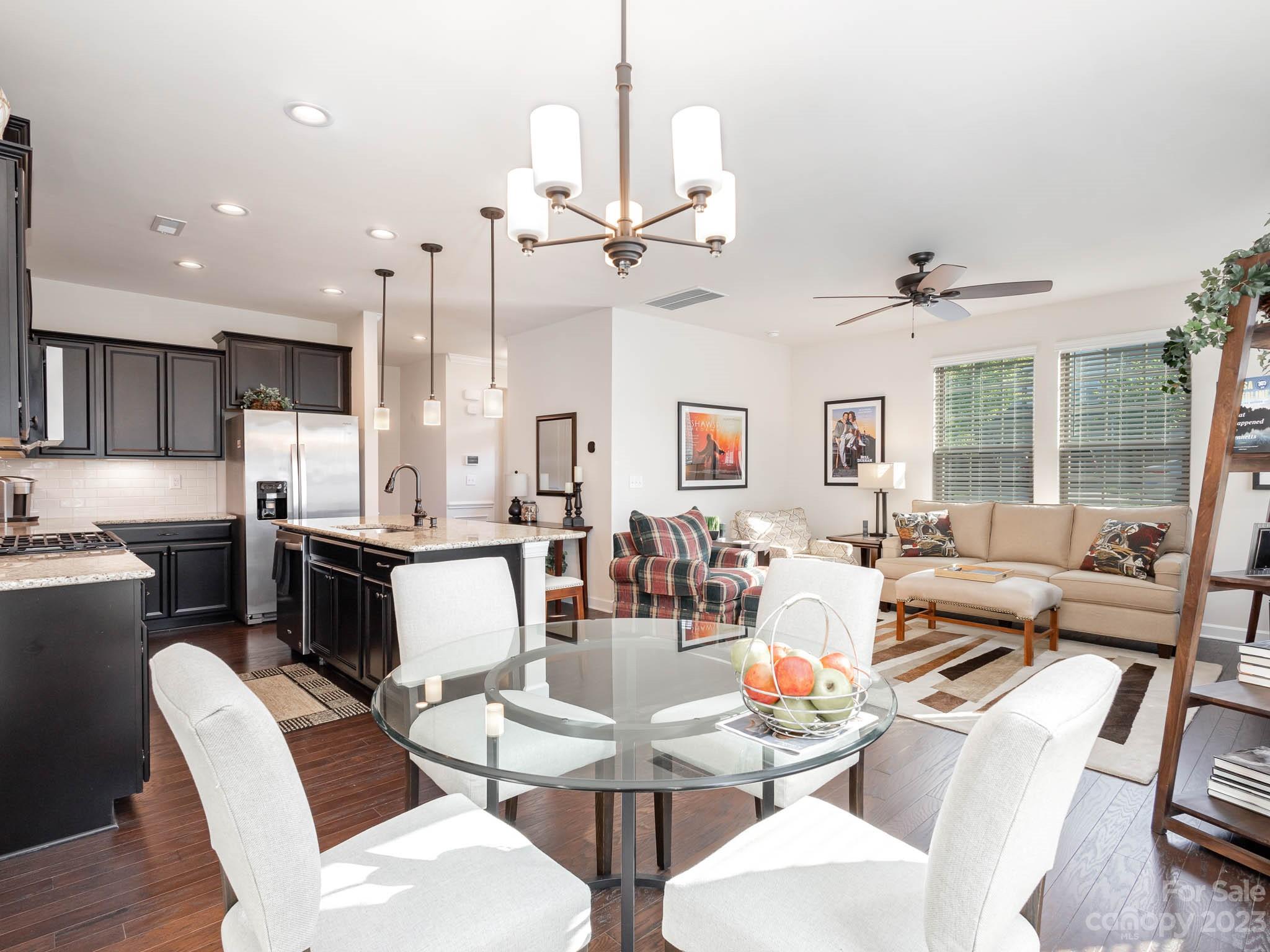 5688 Garrow Glen Road Charlotte, NC 28278 - Photo 6 of 30 a living room with lots of furniture kitchen view and a chandelier