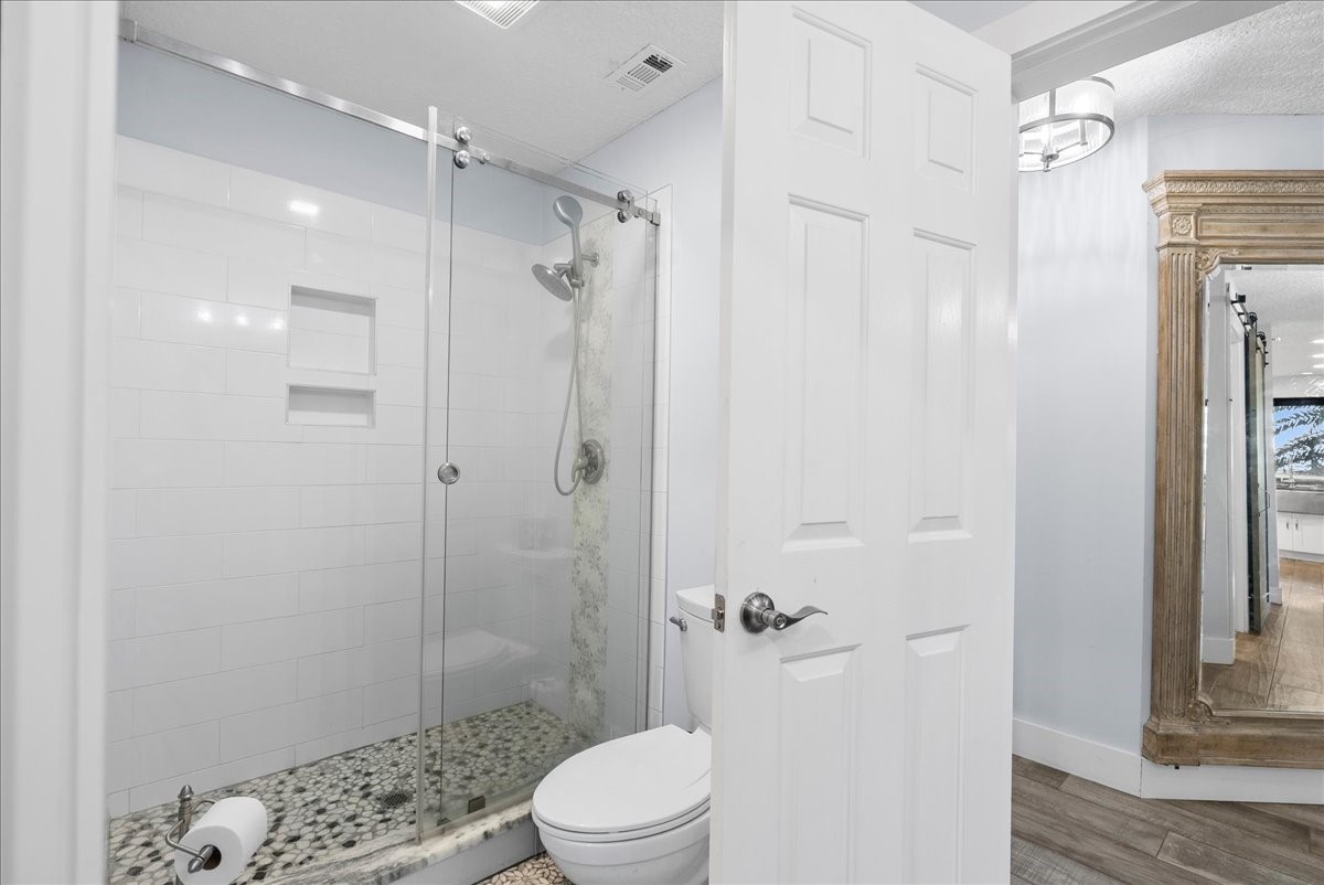 85316 Avant Road Yulee, FL 32097 - Photo 37 of 62 a bathroom with a shower a toilet and a shower