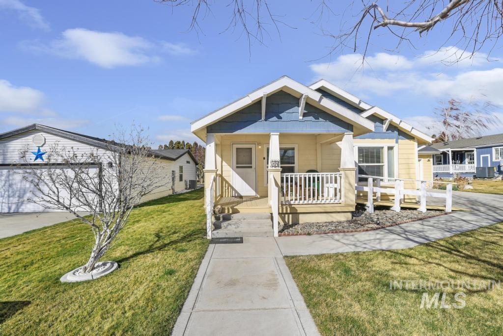 910 Moonglo Road, Unit 14 Buhl, ID 83316 - Photo 1 of 22 View of front of house featuring a front yard, covered porch, and a garage