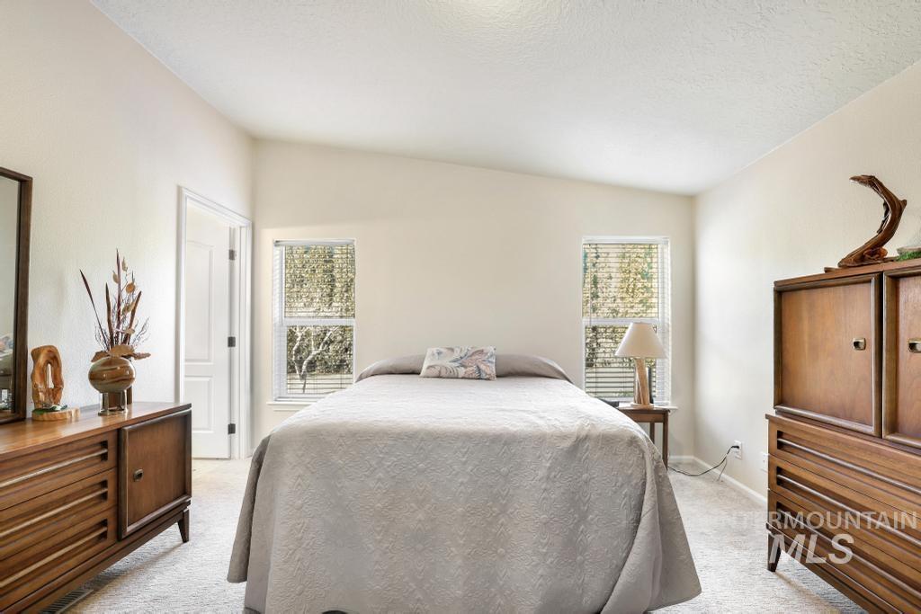 910 Moonglo Road, Unit 14 Buhl, ID 83316 - Photo 12 of 22 Bedroom featuring light carpet and a textured ceiling