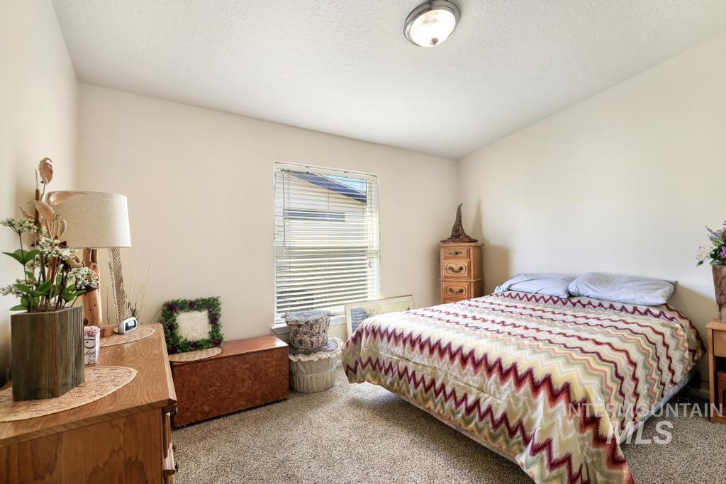 910 Moonglo Road, Unit 14 Buhl, ID 83316 - Photo 15 of 22 Carpeted bedroom featuring a textured ceiling