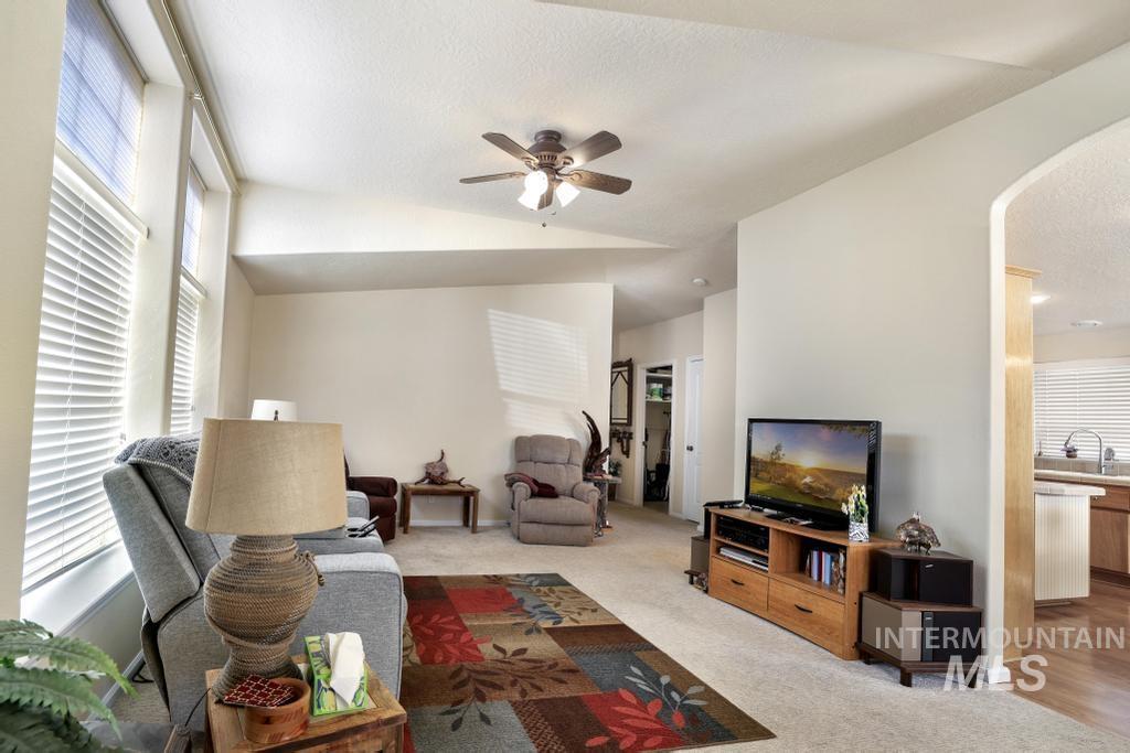 910 Moonglo Road, Unit 14 Buhl, ID 83316 - Photo 5 of 22 Living area featuring arched walkways, carpet, and ceiling fan