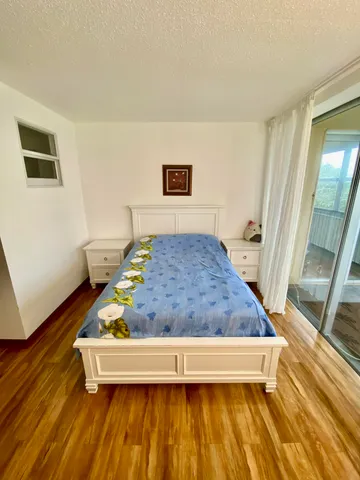 a living room with a bed and a table