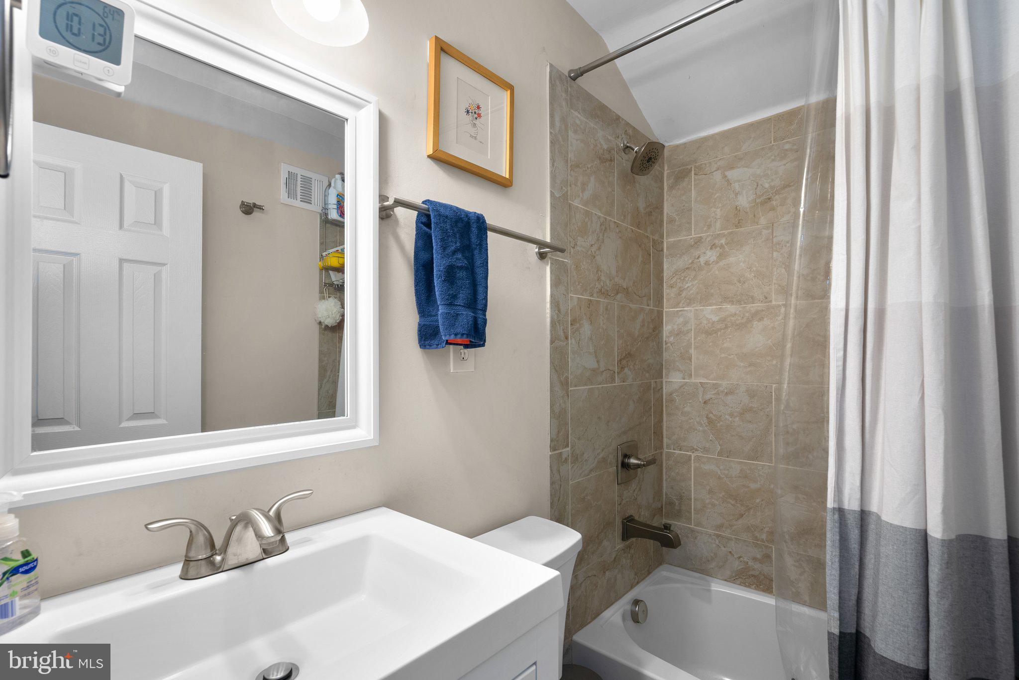 12837 Flack Street Silver Spring, MD 20906 - Photo 15 of 26 a bathroom with a sink and a mirror