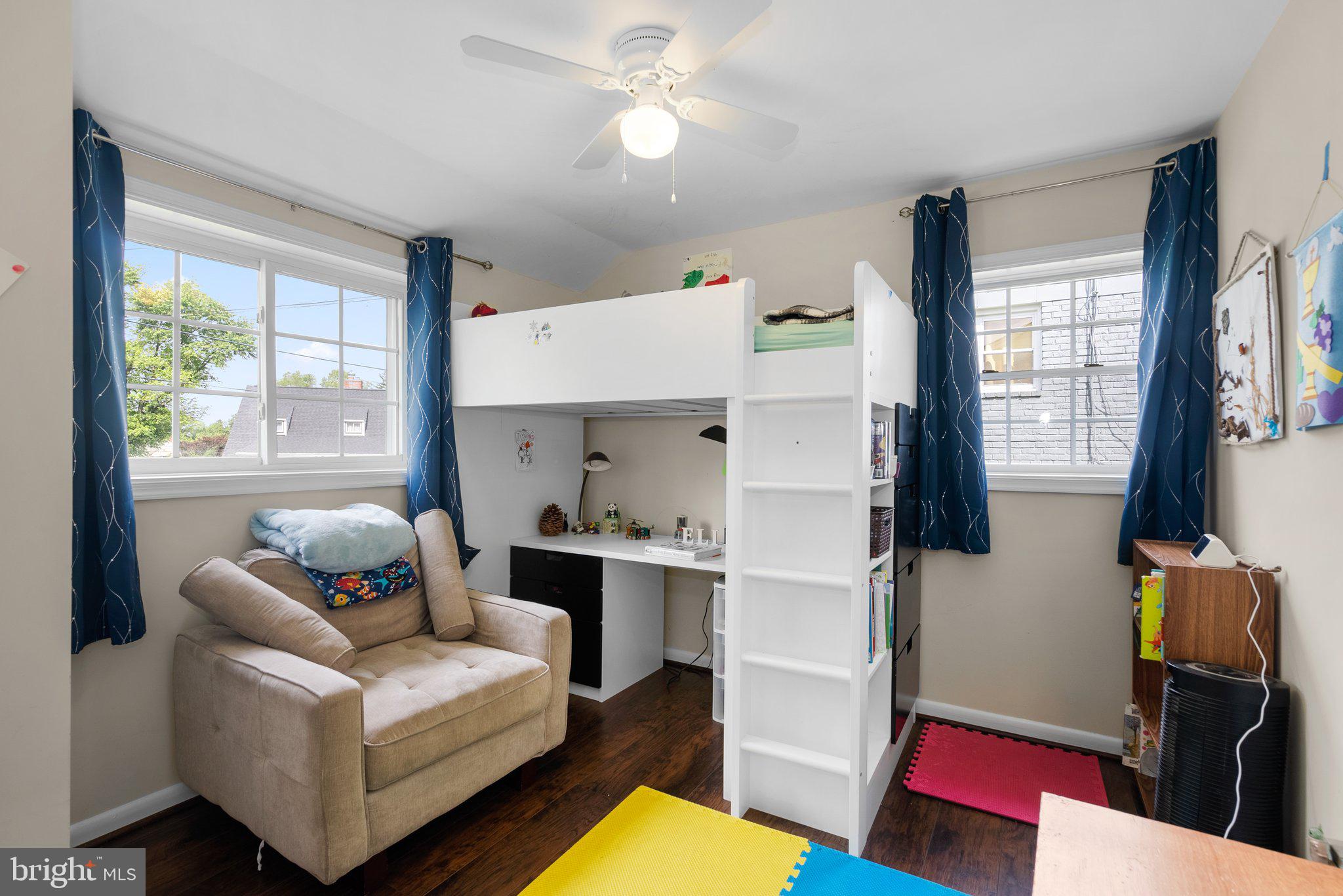 12837 Flack Street Silver Spring, MD 20906 - Photo 17 of 26 a living room with furniture and a flat screen tv