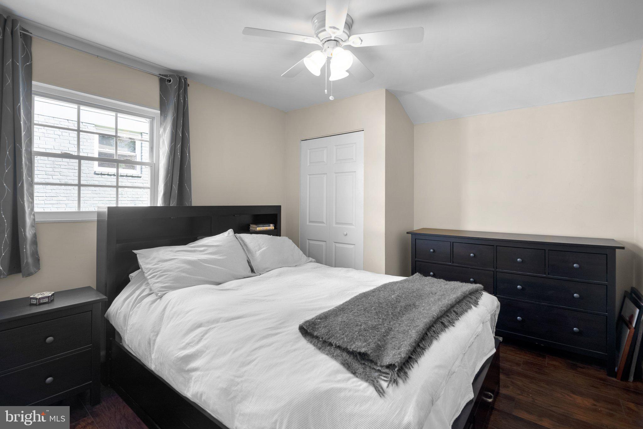 12837 Flack Street Silver Spring, MD 20906 - Photo 18 of 26 a bedroom with a bed and a dresser