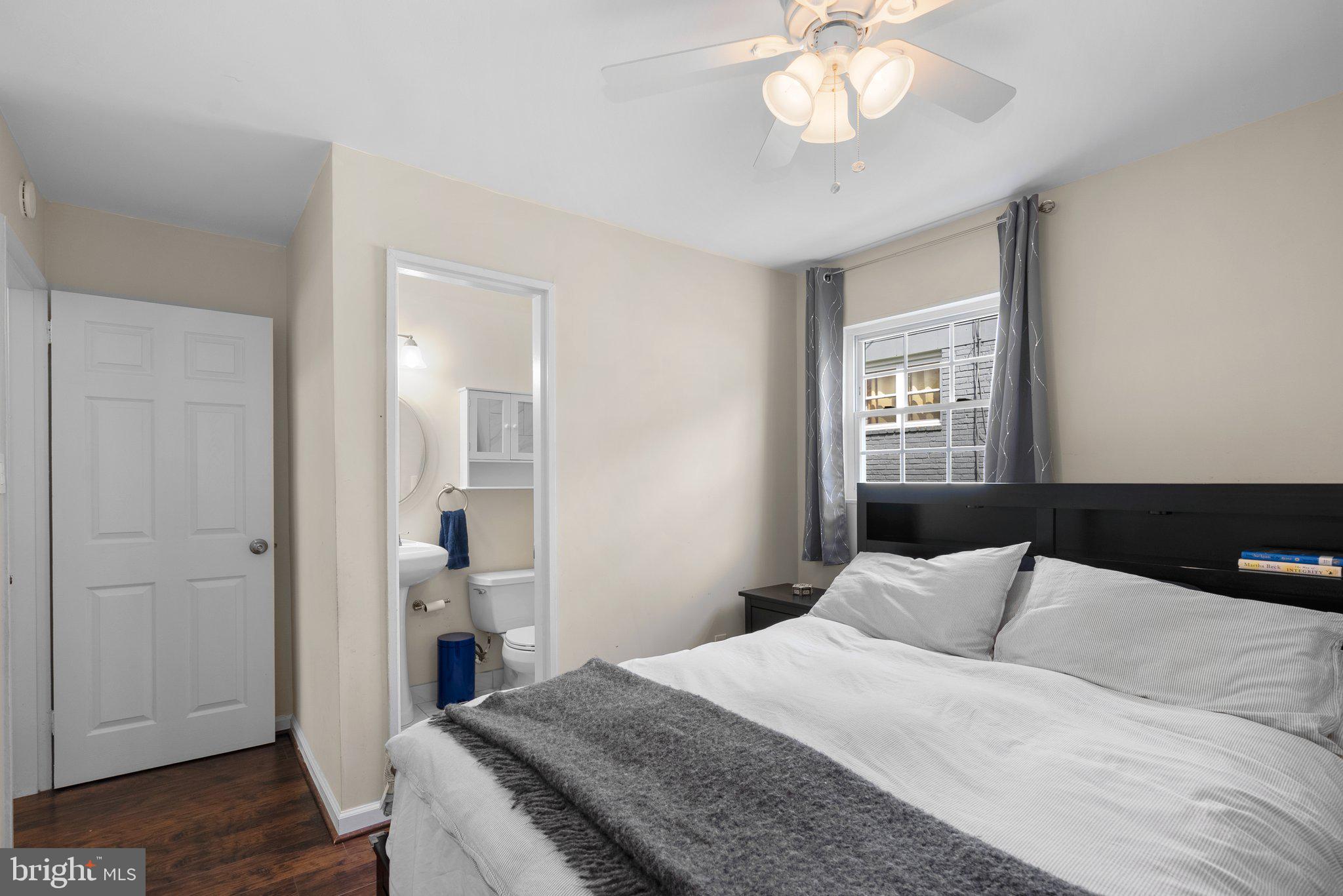 12837 Flack Street Silver Spring, MD 20906 - Photo 19 of 26 a bedroom with a bed and a chandelier