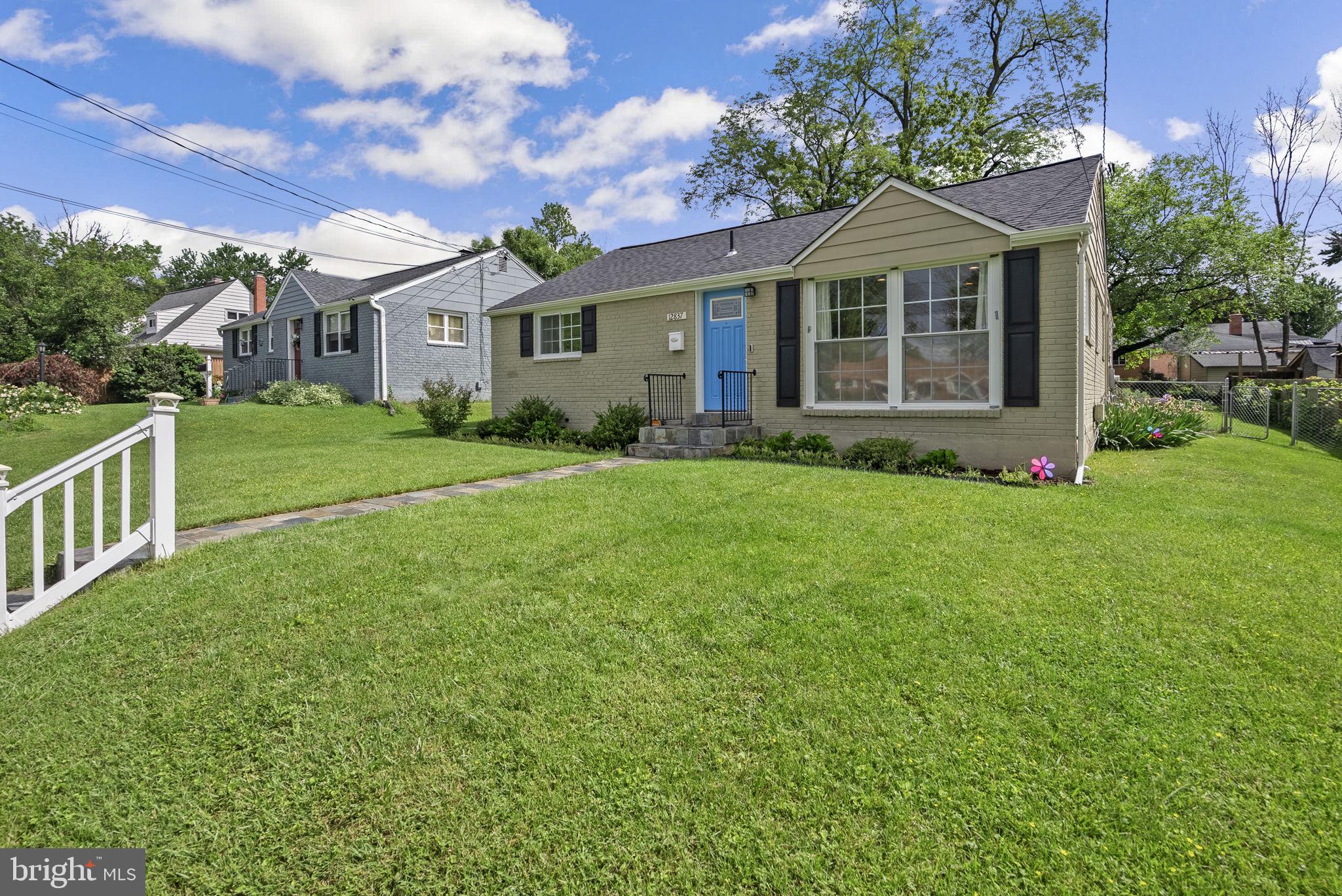 12837 Flack Street Silver Spring, MD 20906 - Photo 2 of 26 a front view of a house with a yard