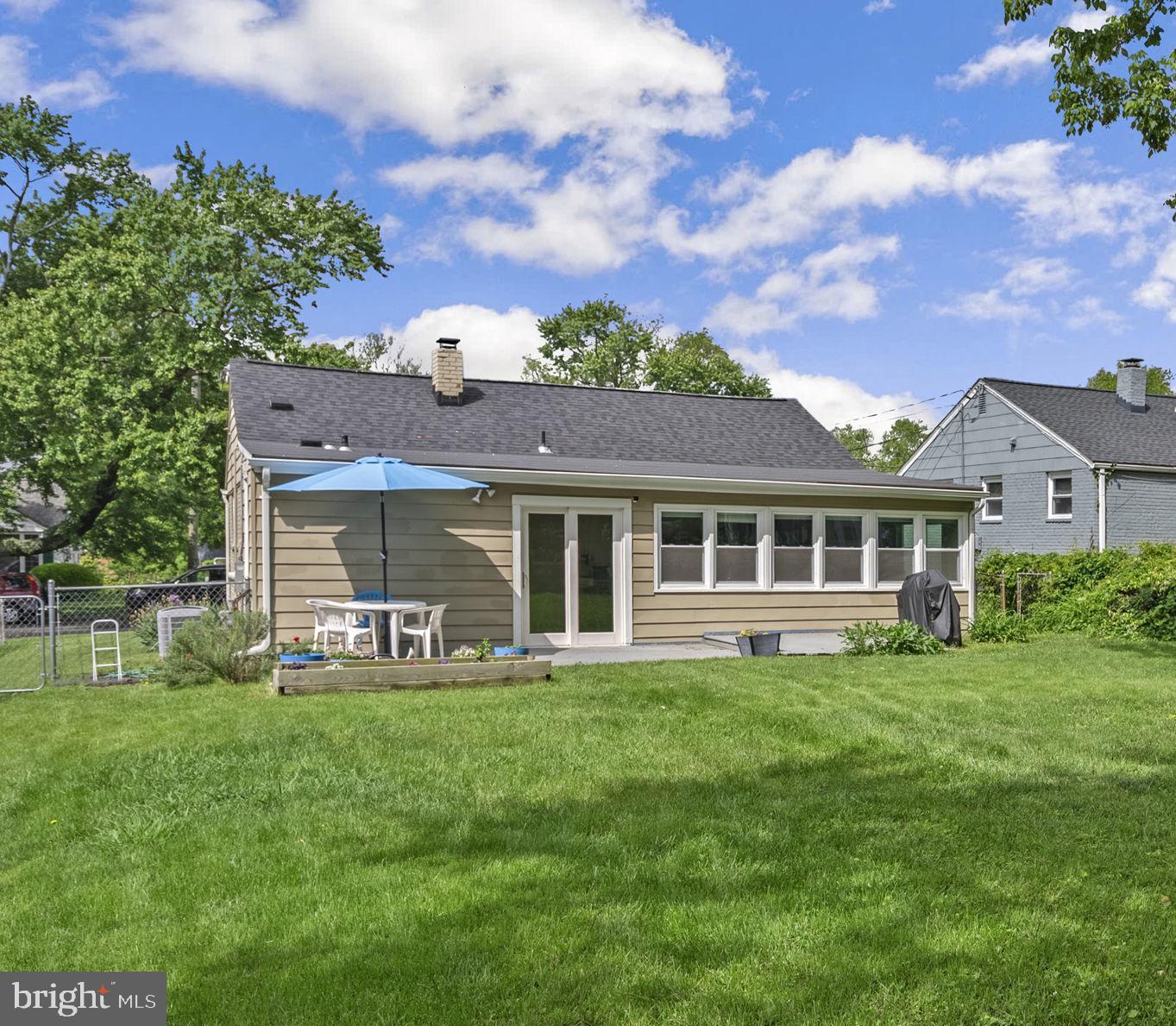 12837 Flack Street Silver Spring, MD 20906 - Photo 23 of 26 a front view of a house with garden
