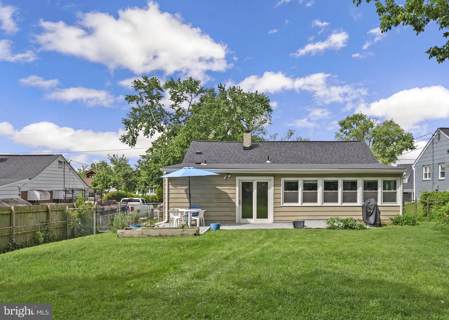 12837 Flack Street Silver Spring, MD 20906 - Photo 24 of 26 a front view of a house with a garden