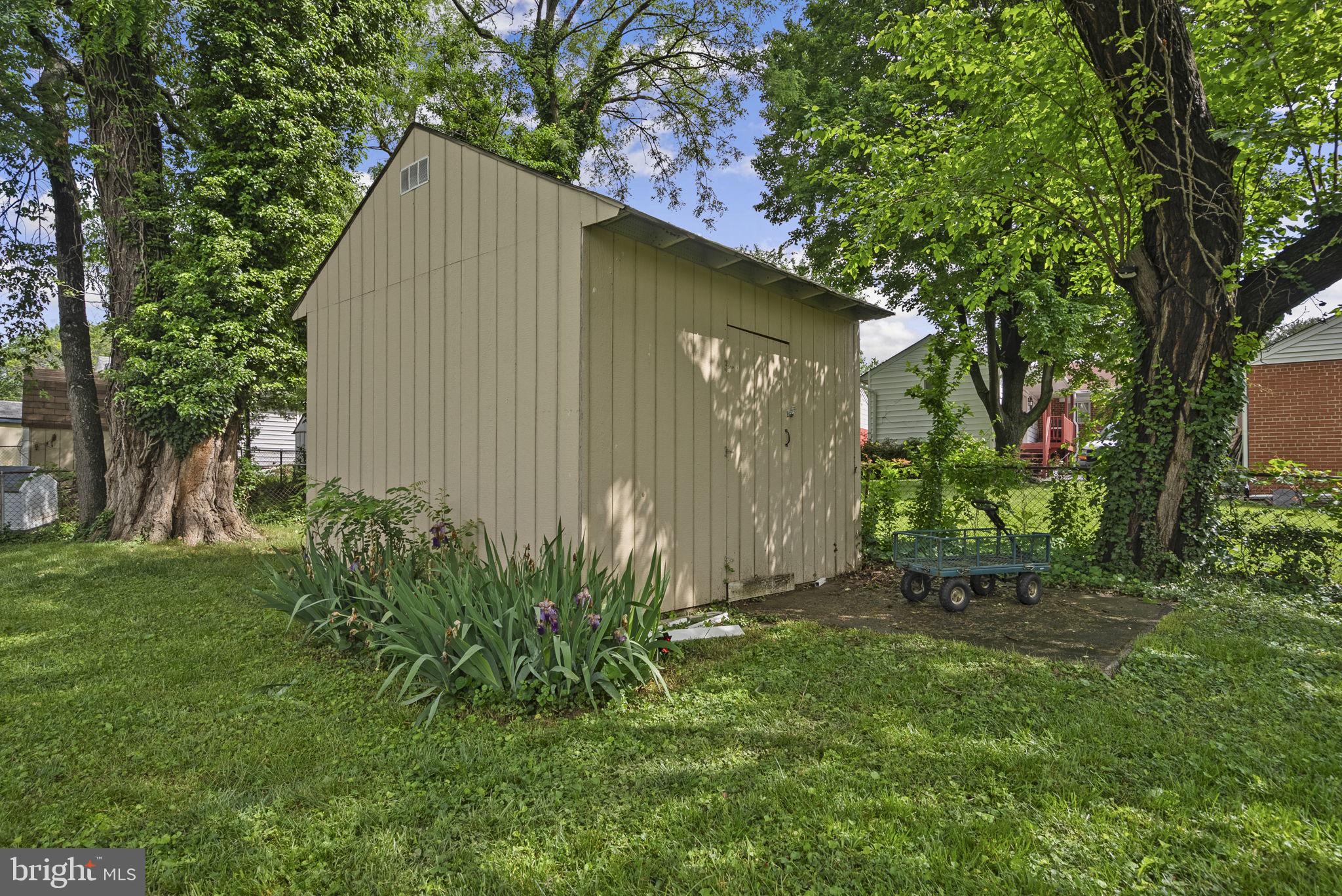 12837 Flack Street Silver Spring, MD 20906 - Photo 26 of 26 a house with a tree in front of it