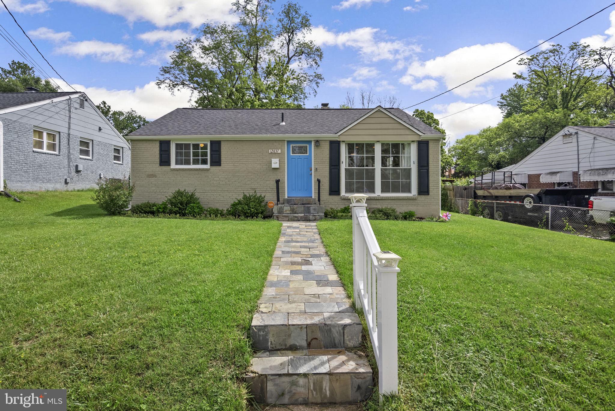 12837 Flack Street Silver Spring, MD 20906 - Photo 3 of 26 a front view of a house with yard
