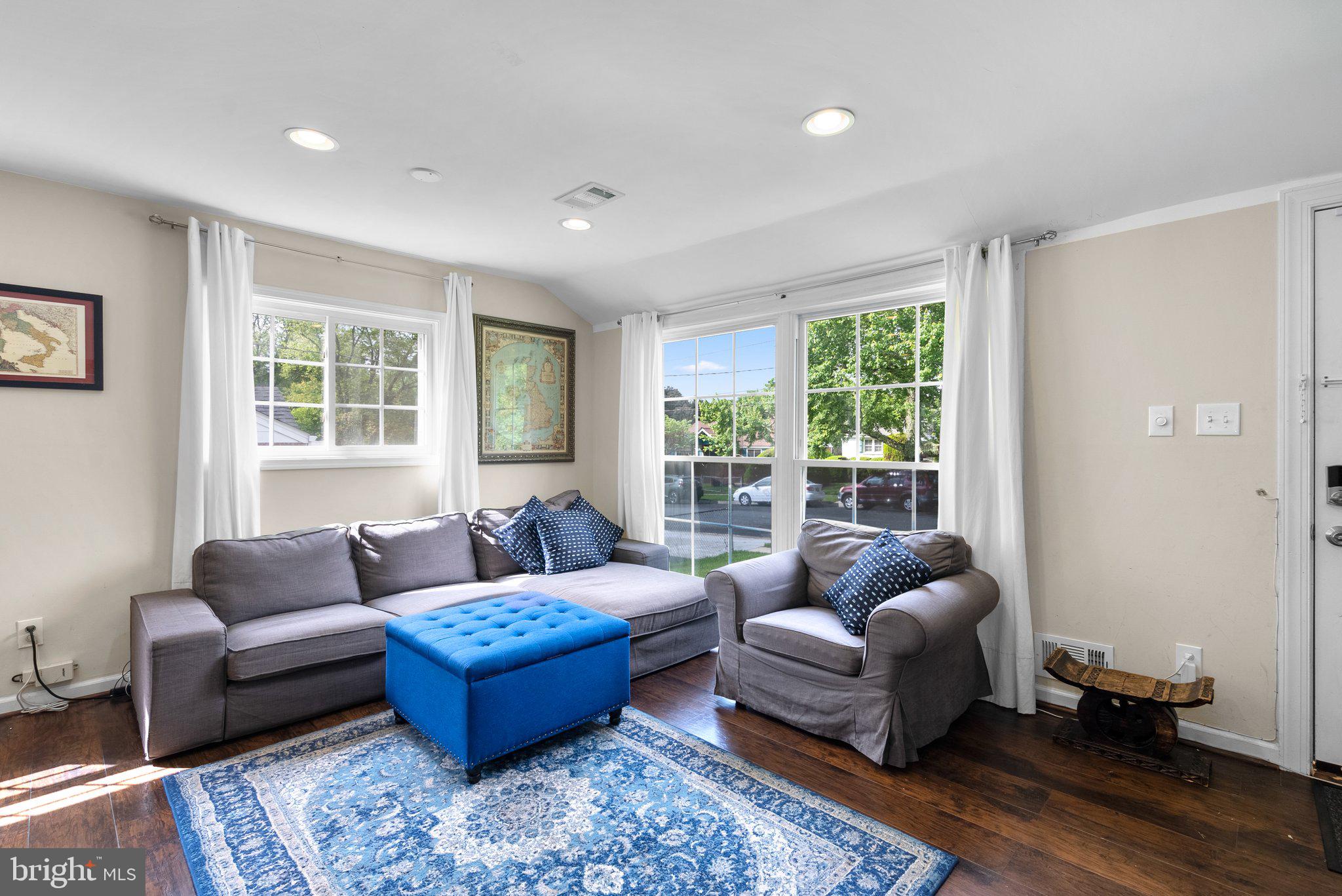12837 Flack Street Silver Spring, MD 20906 - Photo 5 of 26 a living room with furniture and a large window