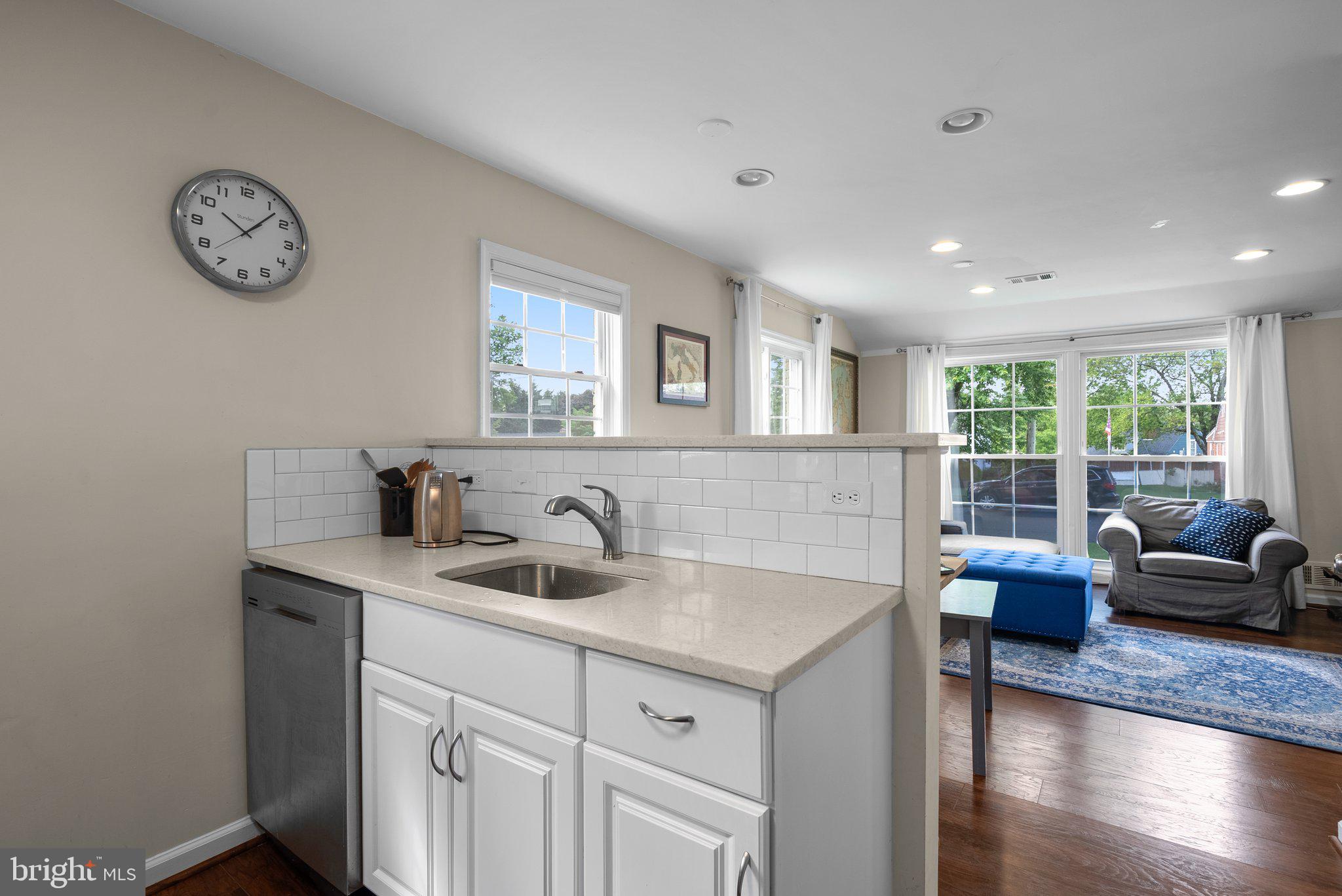12837 Flack Street Silver Spring, MD 20906 - Photo 9 of 26 a view of a kitchen with a sink and a wooden floor
