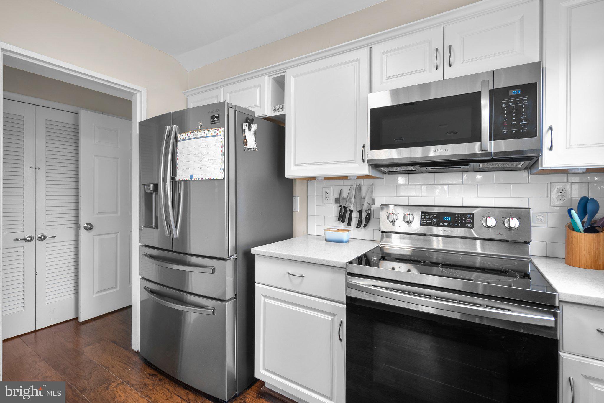 12837 Flack Street Silver Spring, MD 20906 - Photo 10 of 26 a kitchen with stainless steel appliances and wooden floor