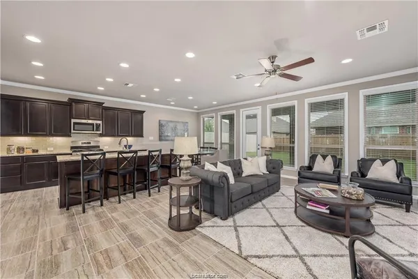a living room with furniture and kitchen view