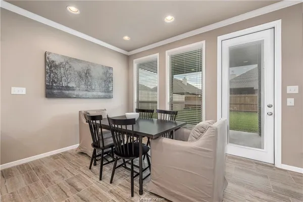 a dining room with furniture and wooden floor