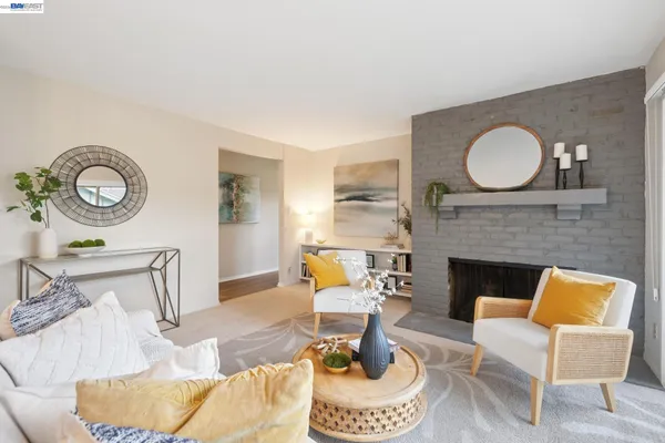 a living room with furniture a clock and a fireplace