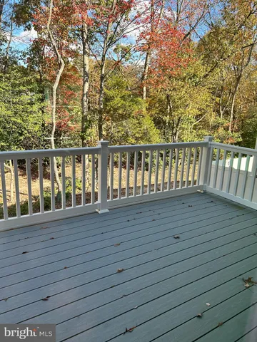a view of balcony with wooden floor and fence
