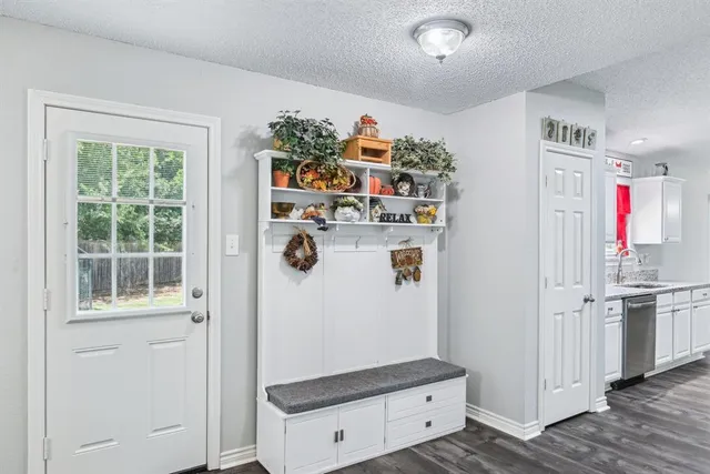 a view of kitchen with stainless steel appliances granite countertop cabinets and a window