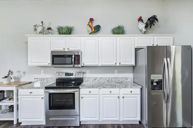 a kitchen with appliances a sink and cabinets
