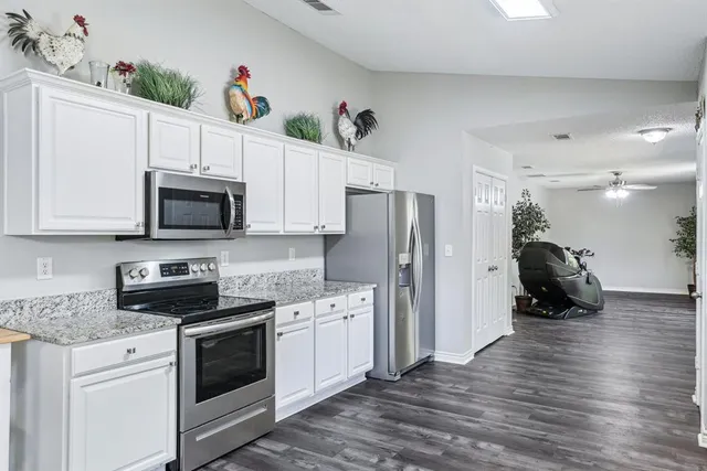a kitchen with stainless steel appliances a stove microwave and a refrigerator