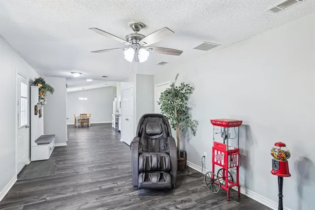 a view of a livingroom with furniture wooden floor and a chandelier
