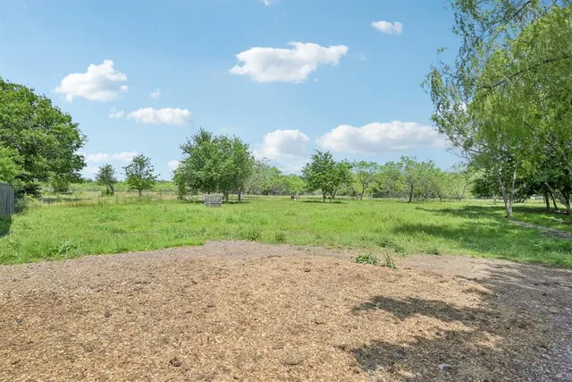 an aerial view of a houses with a yard