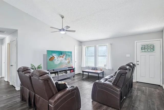 a living room with furniture a projector and a window