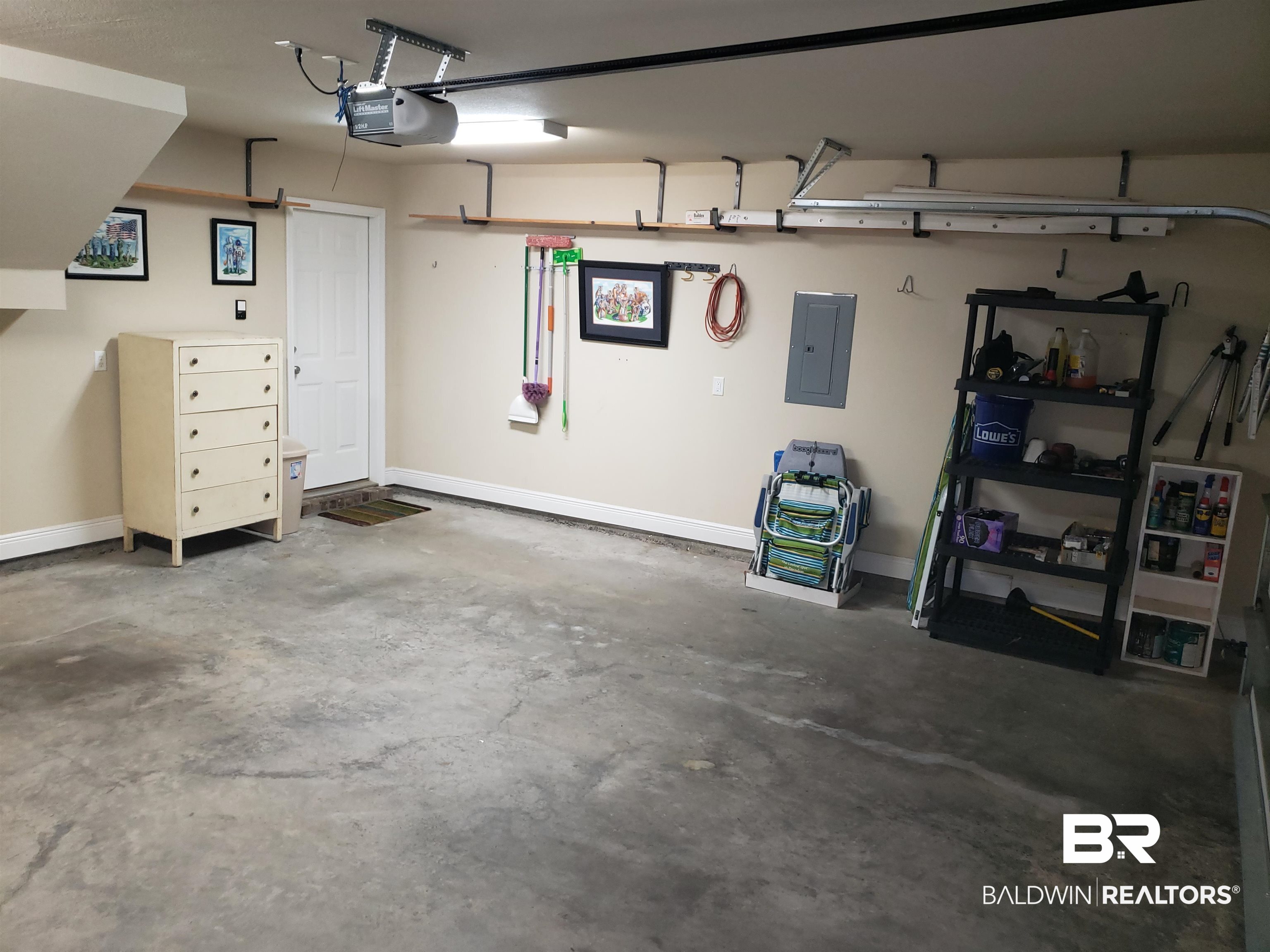 23373 Dundee Circle Foley, AL 36535 - Photo 24 of 34 Garage with electric panel, water heater, garage door opener, shelves for Storm Panels