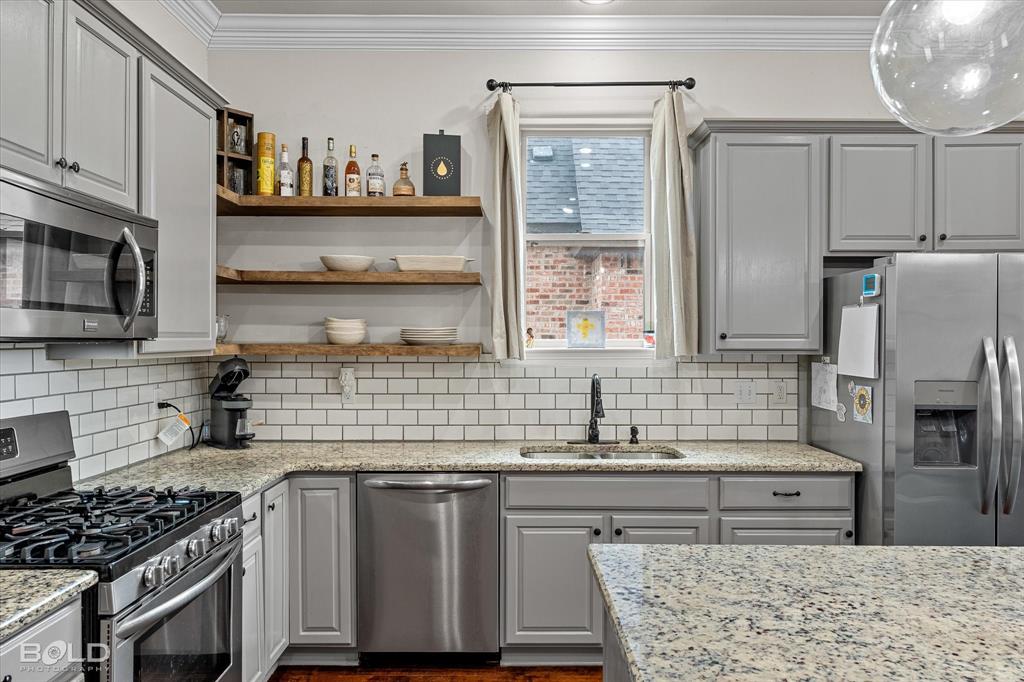 946 Maize Street Bossier City, LA 71111 - Photo 22 of 39 a kitchen with stainless steel appliances granite countertop a sink stove and refrigerator