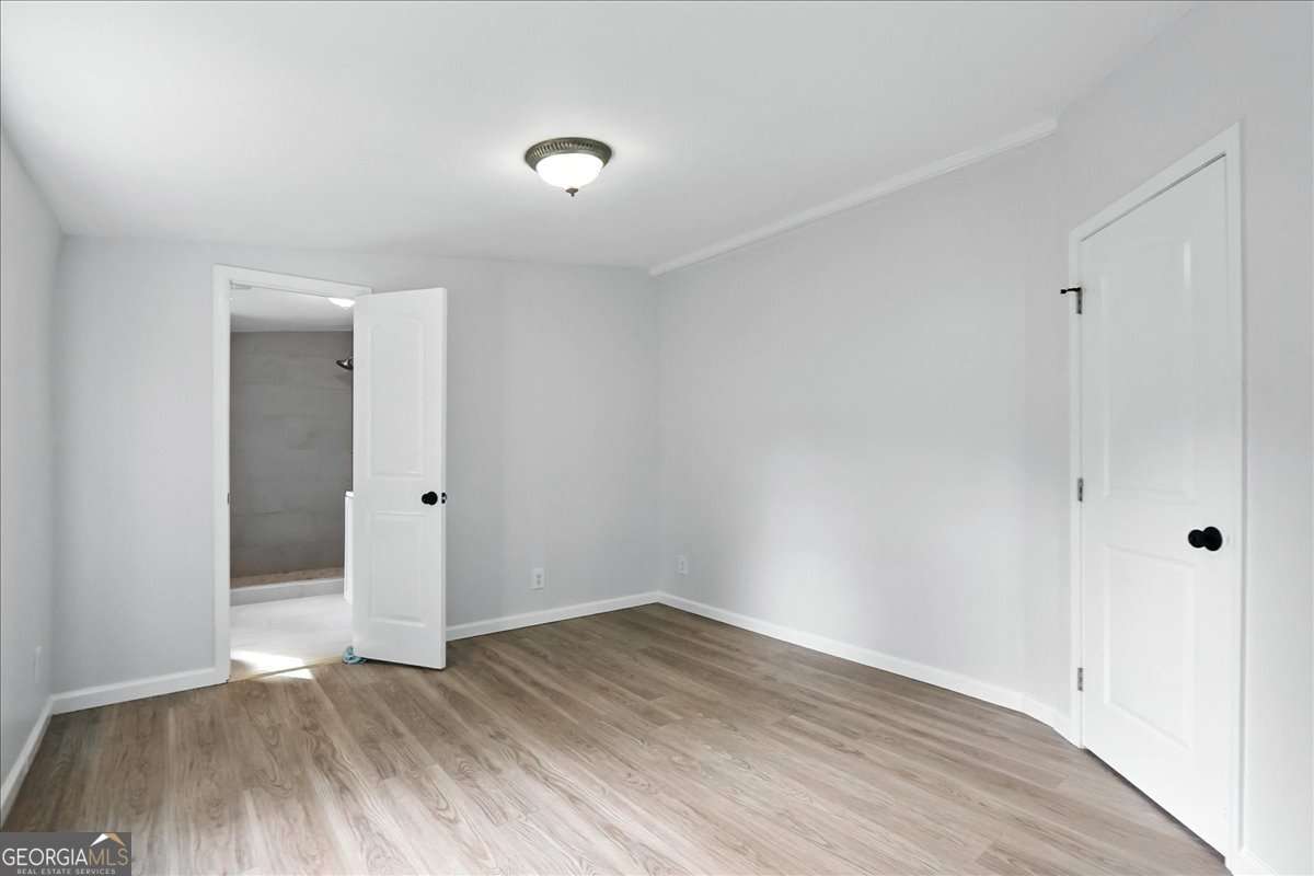 285 Trotters Way Jefferson, GA 30549 - Photo 13 of 28 a view of an empty room with wooden floor