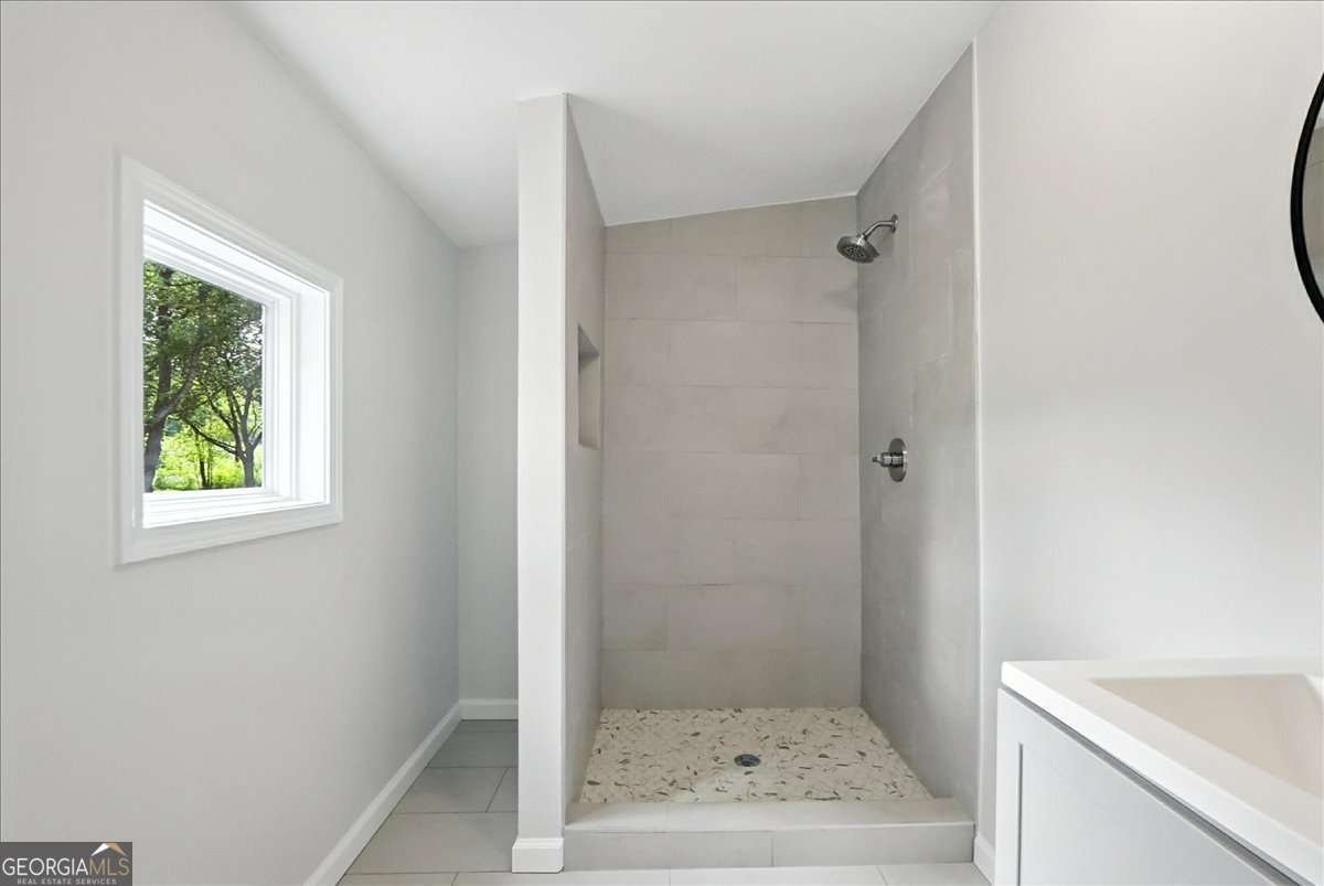 285 Trotters Way Jefferson, GA 30549 - Photo 14 of 28 a bathroom with a shower and a sink