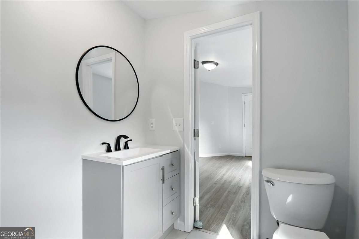 285 Trotters Way Jefferson, GA 30549 - Photo 15 of 28 a bathroom with a sink a toilet and a mirror