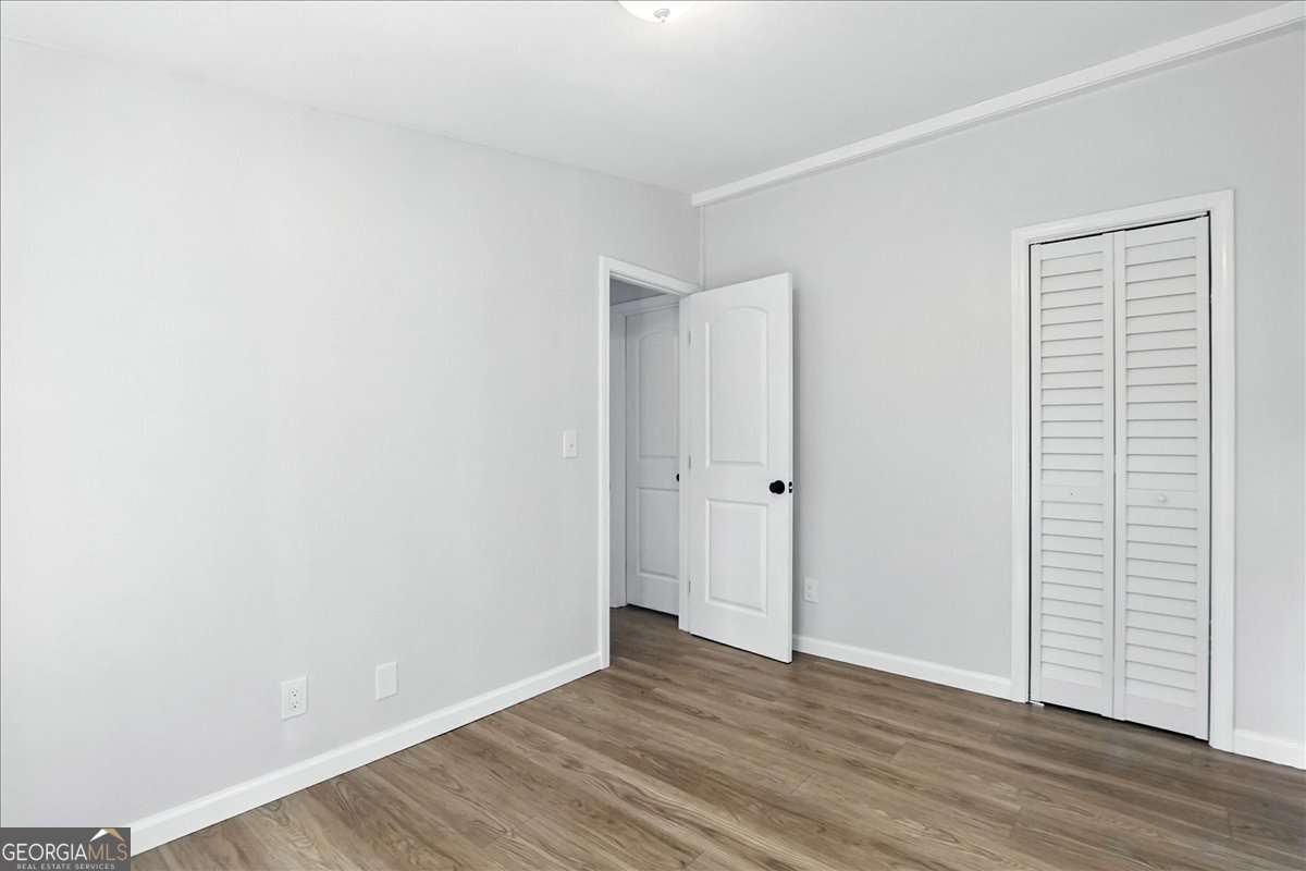 285 Trotters Way Jefferson, GA 30549 - Photo 17 of 28 a view of an empty room with wooden floor and closet