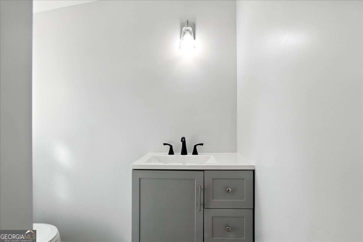 285 Trotters Way Jefferson, GA 30549 - Photo 19 of 28 a bathroom with a sink and a mirror