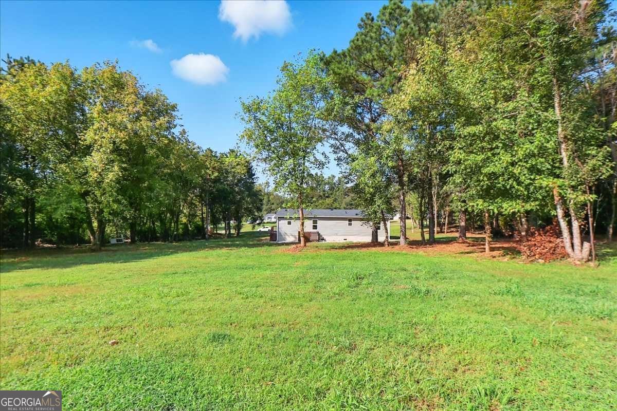 285 Trotters Way Jefferson, GA 30549 - Photo 25 of 28 a house view with a sitting space and garden