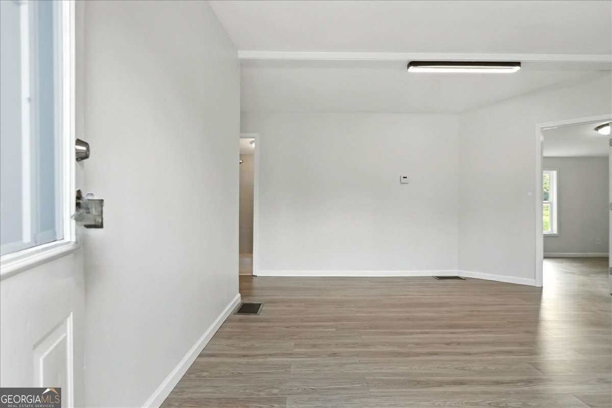 285 Trotters Way Jefferson, GA 30549 - Photo 4 of 28 a view of an empty room with wooden floor