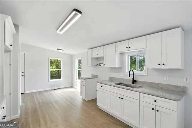 a kitchen with sink and cabinets