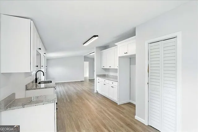 a kitchen with granite countertop a sink and a refrigerator